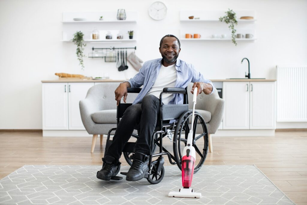 Man with mobility impairment housekeeping with stick vacuum
