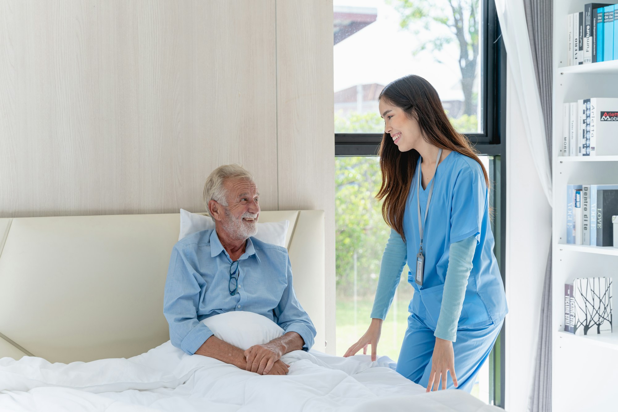 Medical staff taking and caregiver senior man in Home. Home care concept.