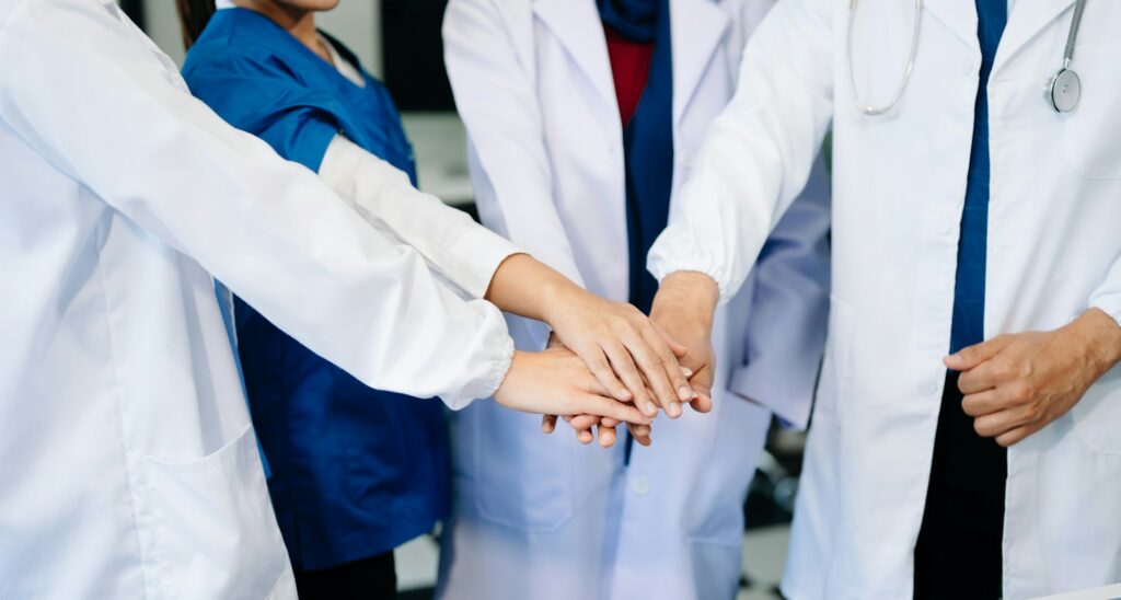 Team Doctors nurses union coordinate hands Teamwork Concept in hospital for success